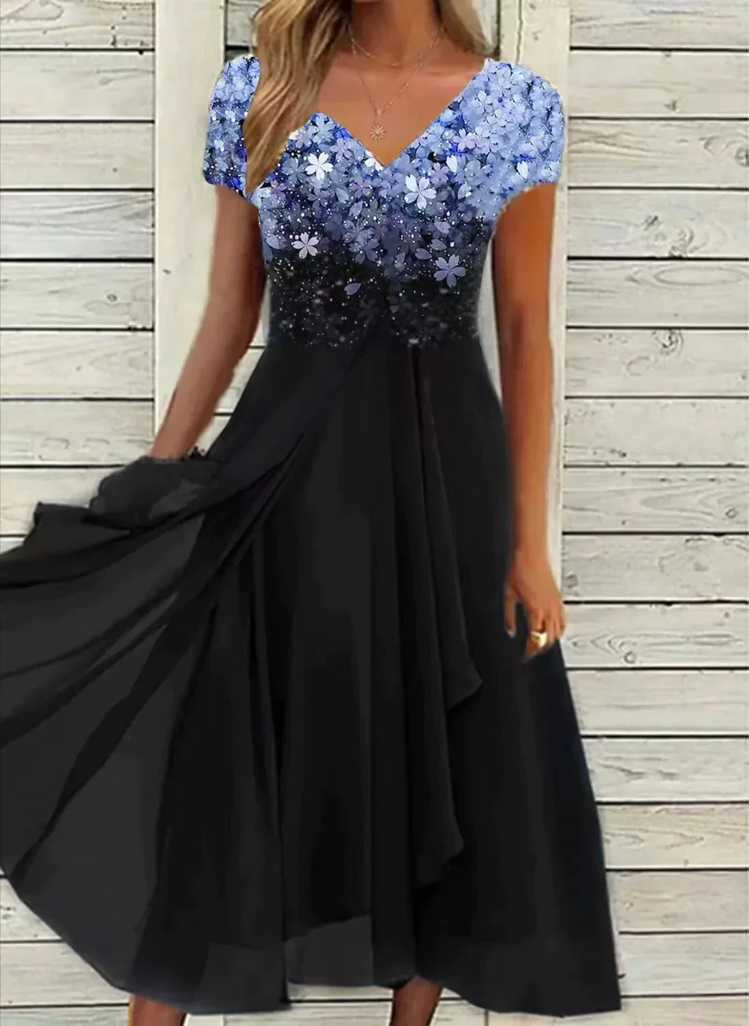 Black dress with blue sequin top against a wooden background