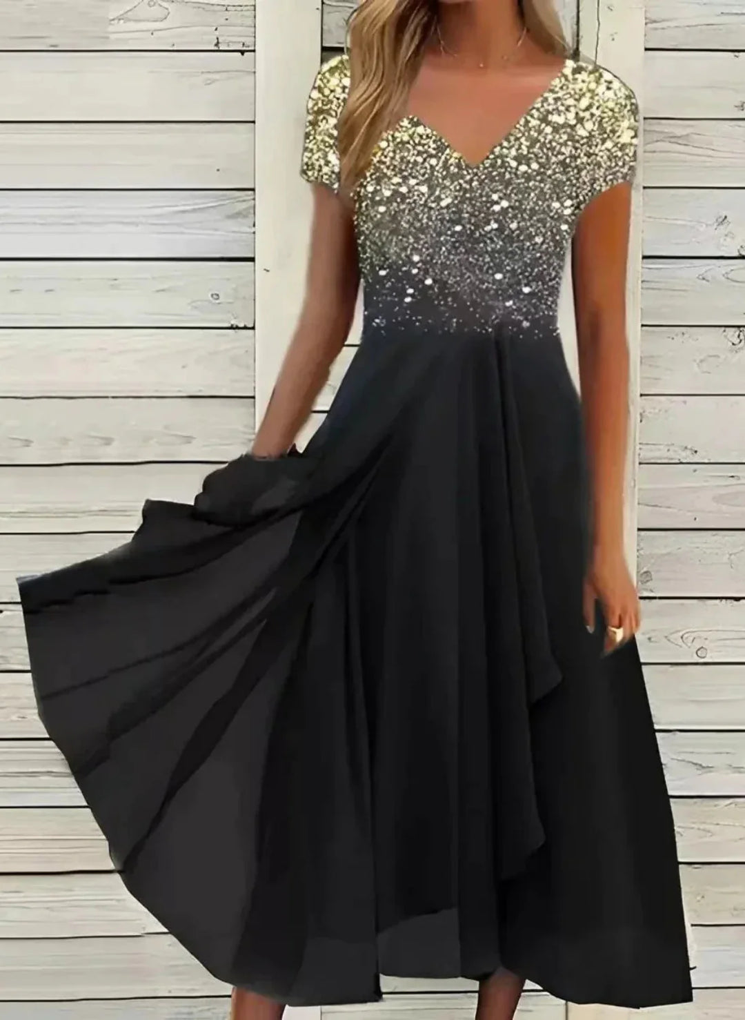 Black dress with a sequined top against a wooden background