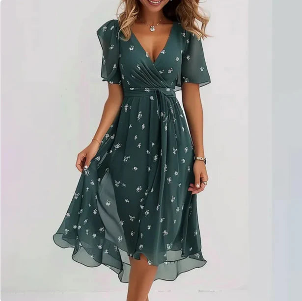 Green floral dress worn by a model on a white background